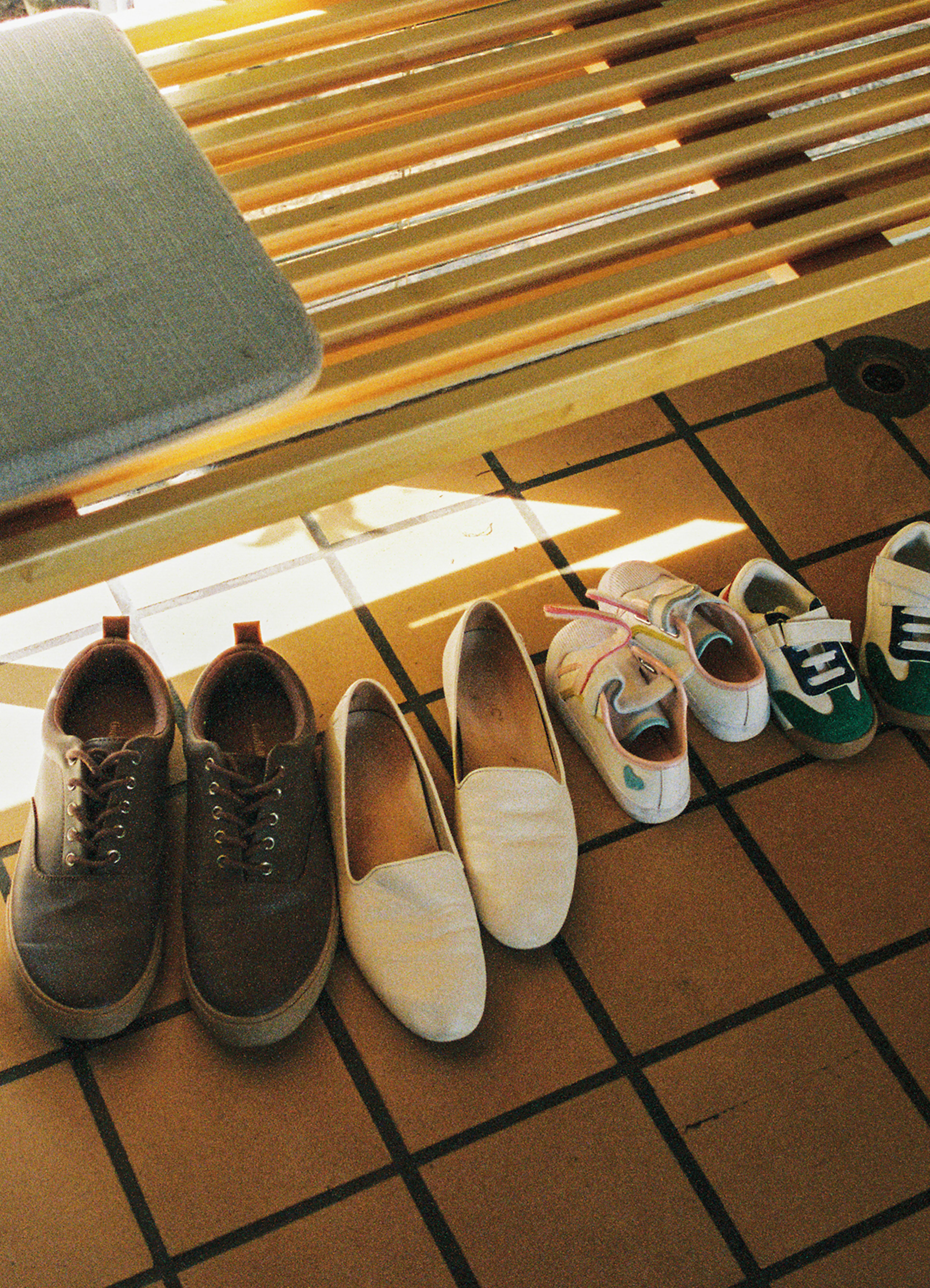 Family’s shoes lined up inside the front door of a home