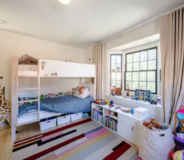 Experience the warmth of family bonding with Kindred home swapping, where kids can enjoy cozy bunk beds and dive into a collection of stories and books. This inviting bedroom reflects the personal touches that make Kindred a unique choice for families, fostering connection and comfort during their stay.