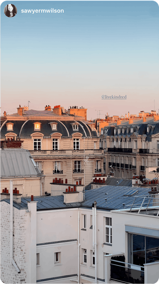 A breathtaking view of European rooftops at sunset, shared by a traveler experiencing home exchange—an immersive way to explore new destinations while staying in real homes.