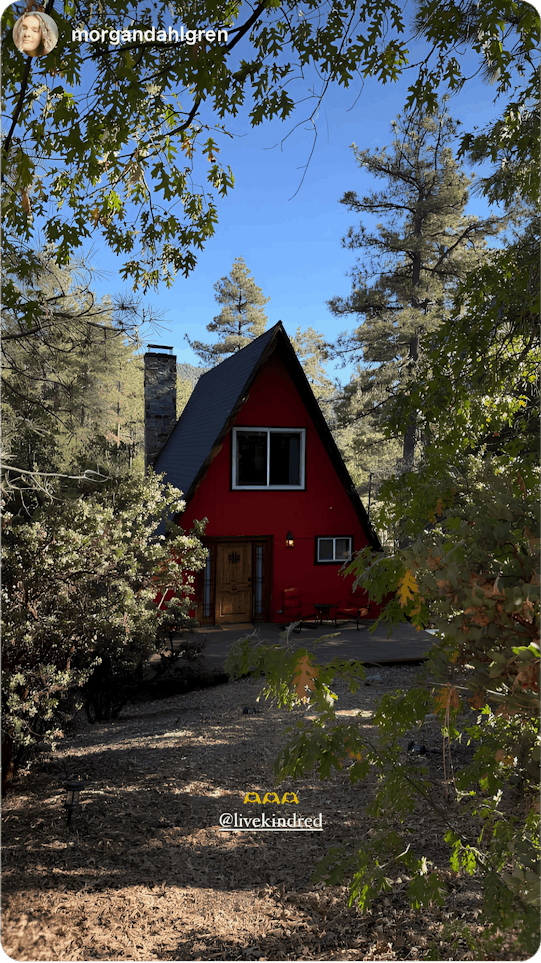 A rustic red A-frame cabin tucked in the woods, highlighting the adventure of house swapping—offering a sustainable and budget-friendly way to travel off the beaten path.
