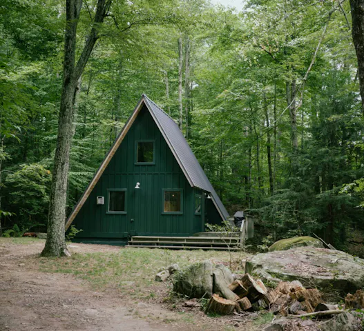 Secluded A-frame cabin in the woods, ideal for retirees and semi-retired adventurers seeking outdoor activities and nature retreats via Kindred home swaps.