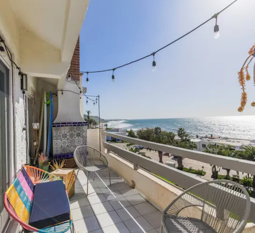 Beachfront balcony with ocean views, ideal for retirees embracing flexible travel, swapping homes through Kindred to enjoy extended stays by the sea.