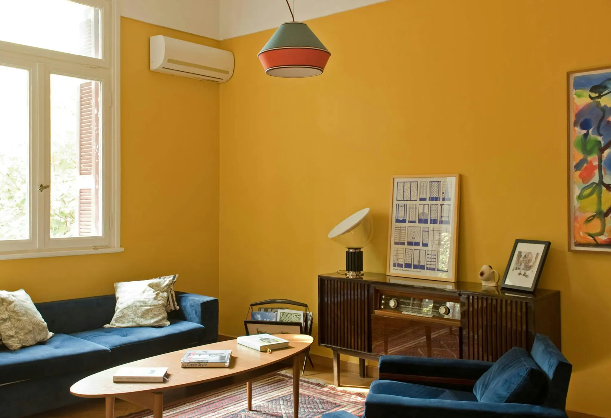 Discover affordable, authentic San Francisco living in a real home, not a hotel. This sun-drenched, budget-friendly home features a stylish wooden dining table, distinct art, comfortable pillows, and spacious rooms, perfect for those seeking a unique and cost-saving Kindred home swap experience in San Francisco.