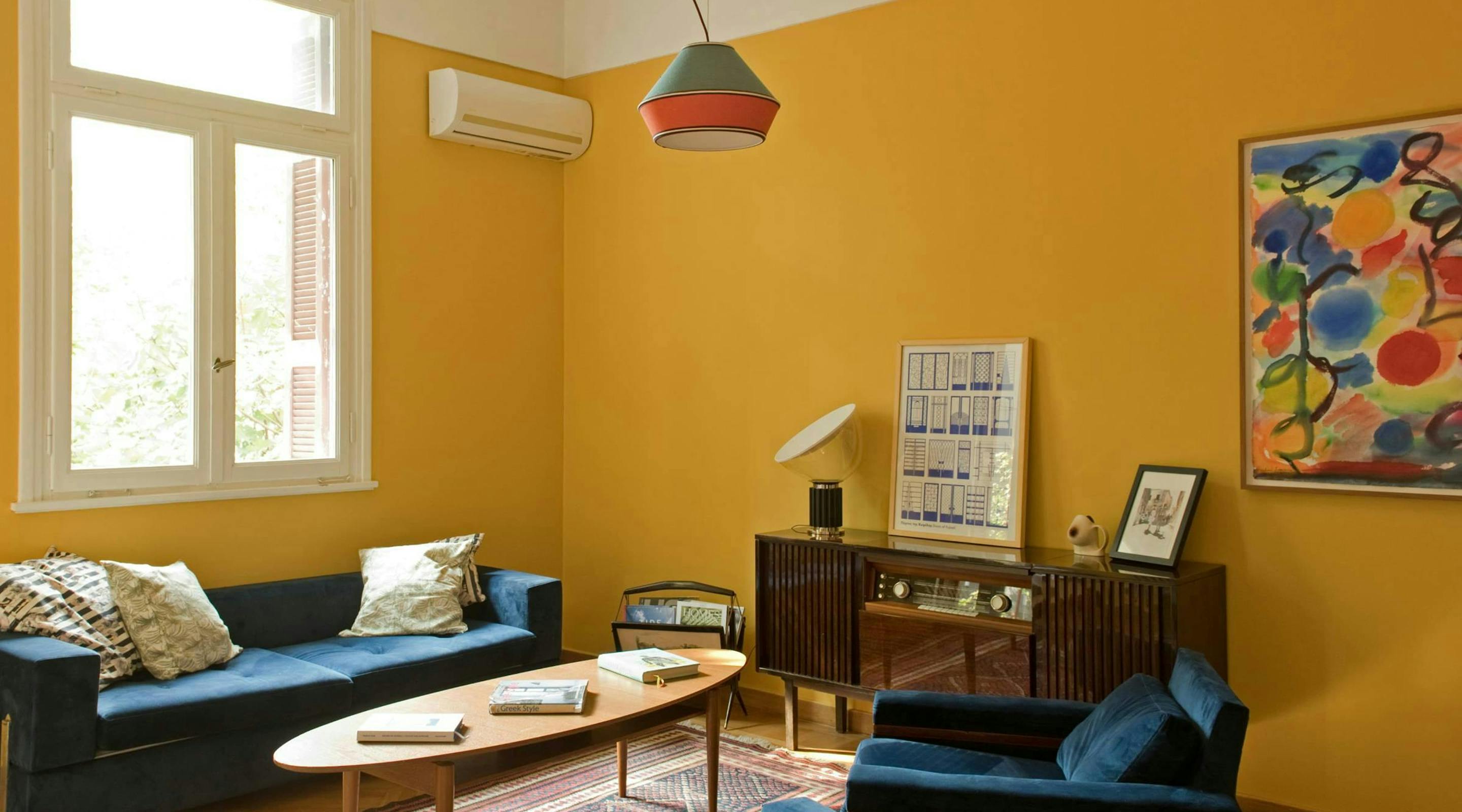 Discover affordable, authentic San Francisco living in a real home, not a hotel. This sun-drenched, budget-friendly home features a stylish wooden dining table, distinct art, comfortable pillows, and spacious rooms, perfect for those seeking a unique and cost-saving Kindred home swap experience in San Francisco.