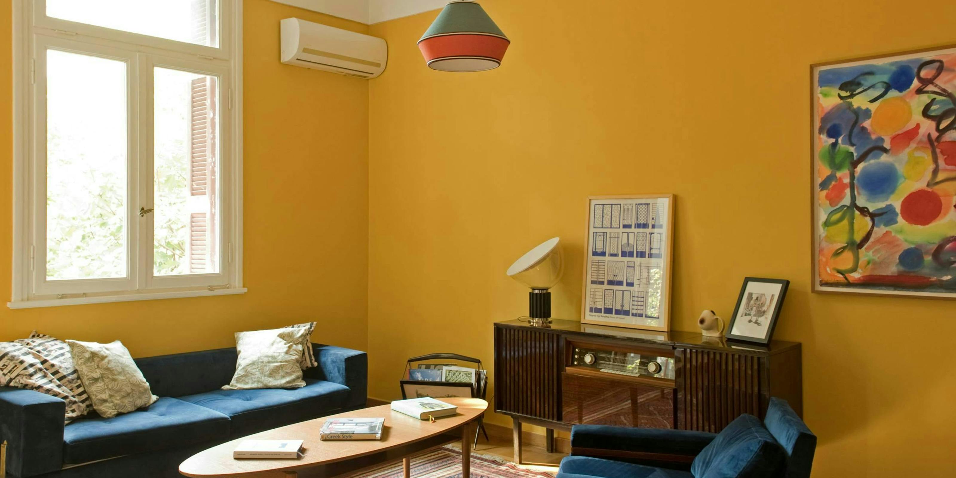 Discover affordable, authentic San Francisco living in a real home, not a hotel. This sun-drenched, budget-friendly home features a stylish wooden dining table, distinct art, comfortable pillows, and spacious rooms, perfect for those seeking a unique and cost-saving Kindred home swap experience in San Francisco.