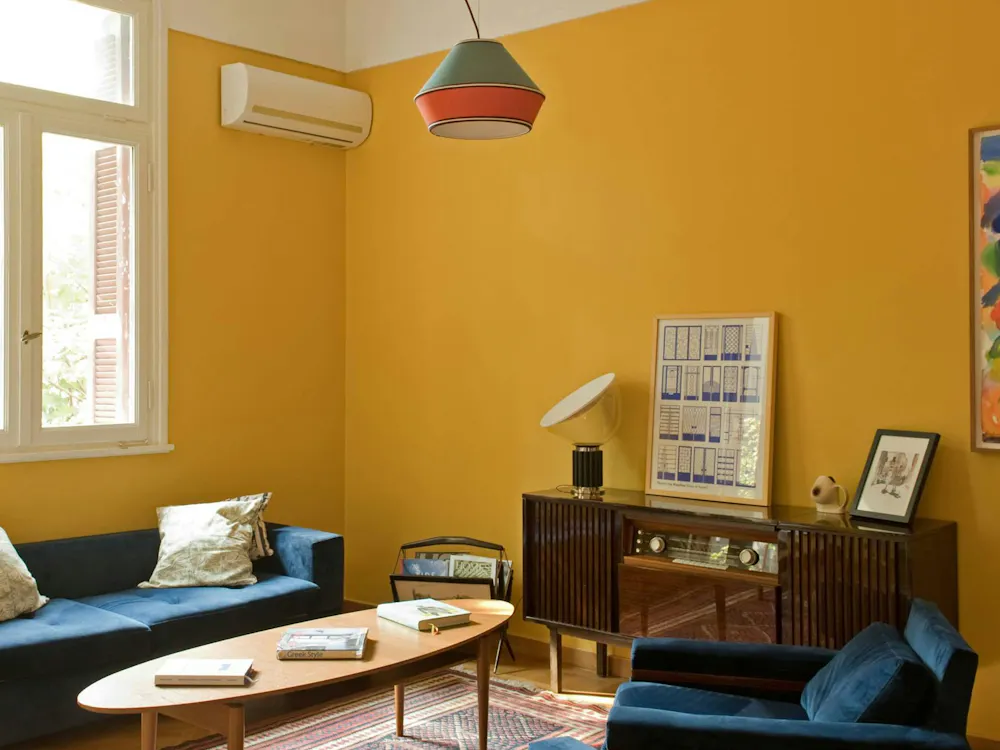 Discover affordable, authentic San Francisco living in a real home, not a hotel. This sun-drenched, budget-friendly home features a stylish wooden dining table, distinct art, comfortable pillows, and spacious rooms, perfect for those seeking a unique and cost-saving Kindred home swap experience in San Francisco.